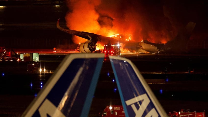 Plane on fire on the tarmac in Tokyo