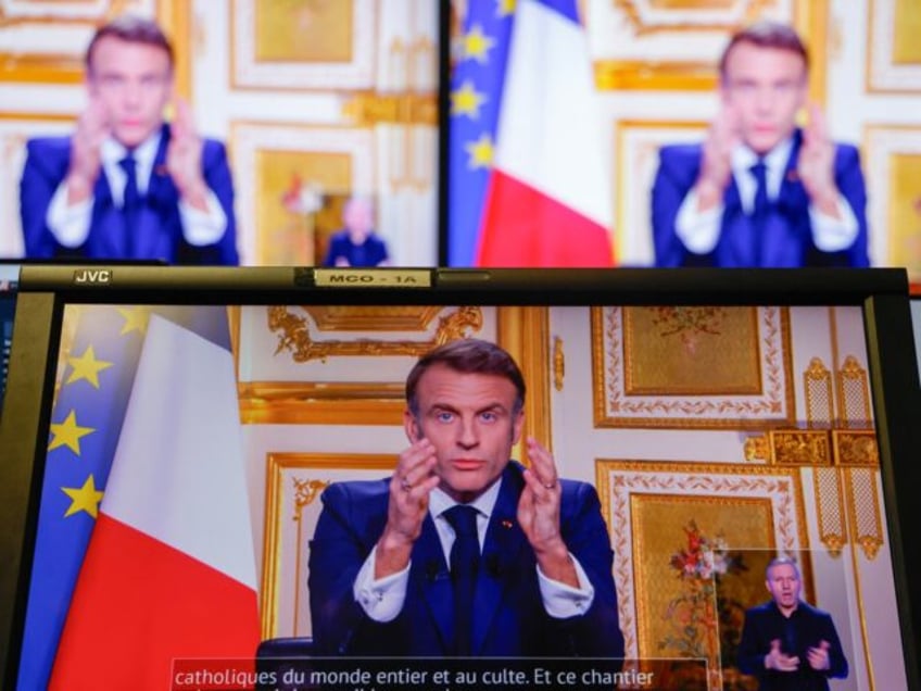 French President Emmanuel Macron is seen on monitors in a control room at AFP headquarters