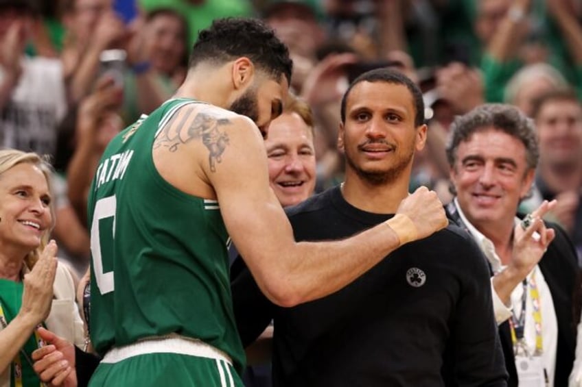 Jayson Tatum (left) hugs Boston Celtics head coach Joe Mazzulla during their series clinch