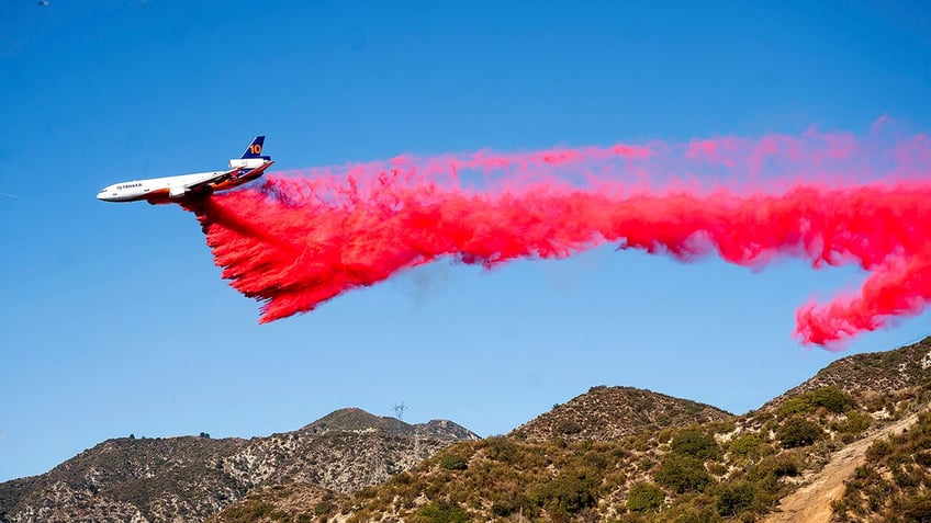 An air tanker drops retardant while working to contain the Eaton Fire