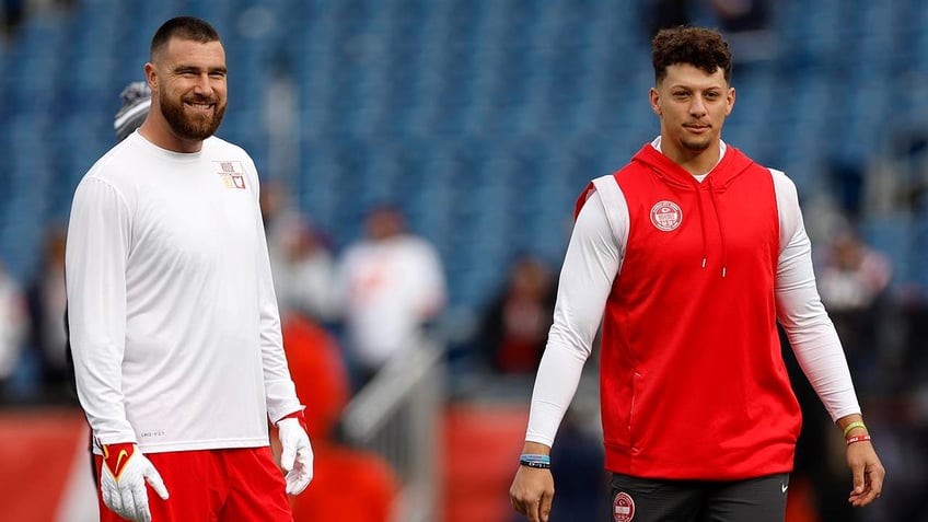 Patrick Mahomes and Travis Kelce look before a game