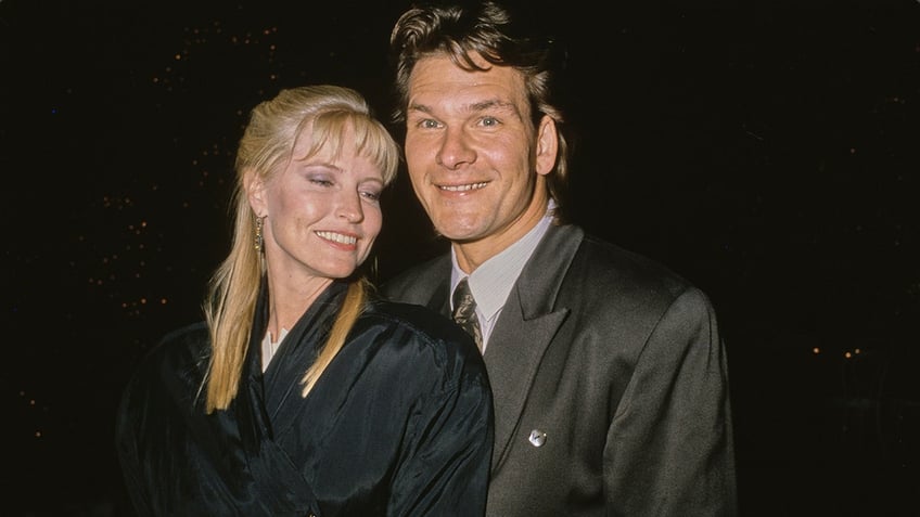 Patrick Swayze and his wife Lisa Niemi Swayze hugging and smiling