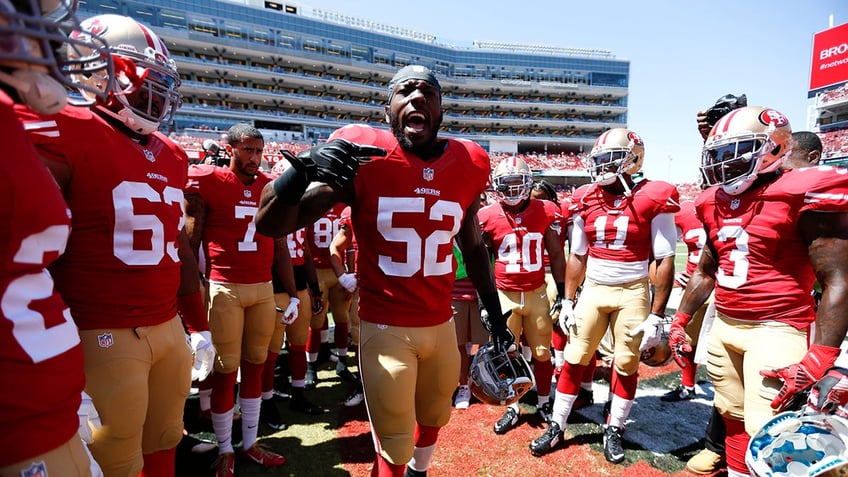 Patrick Willis talks to teammates