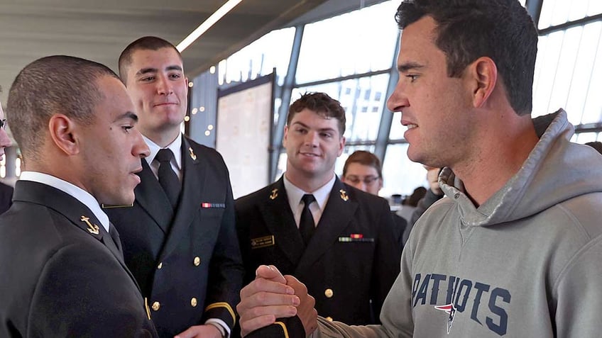 Joe Cardona with Navy players