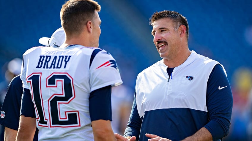 Tom Brady of the New England Patriots talks with head coach Mike Vrabel of the Tennessee Titans before their preseason game in Nashville, Tenn., on August 17, 2019.