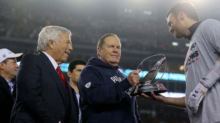 Robert Kraft, head coach Bill Belichick and Tom Brady celebrate with the Lamar Hunt Trophy after winning the AFC championship game at Gillette Stadium on Jan. 22, 2017, in Foxboro, Massachusetts.