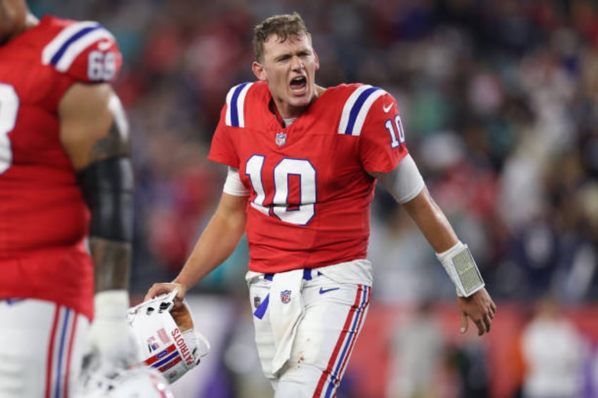 Mac Jones of the New England Patriots reacts after officials overturned a spot to turn the ball over and end the game \amia at Gillette Stadium on...