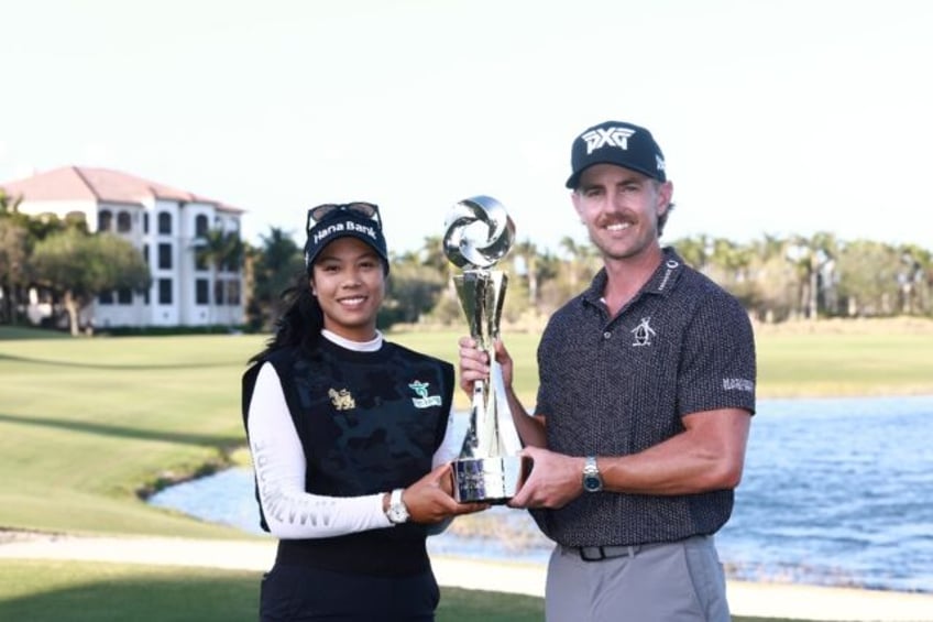 Patty Tavatanakit of Thailand and Jake Knapp of the United States pose with the trophy aft