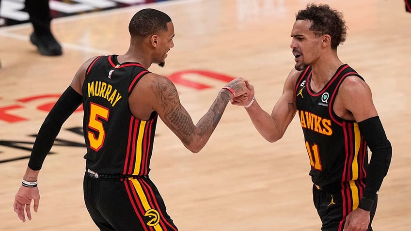 Dejounte Murray and Trae Young fist pound