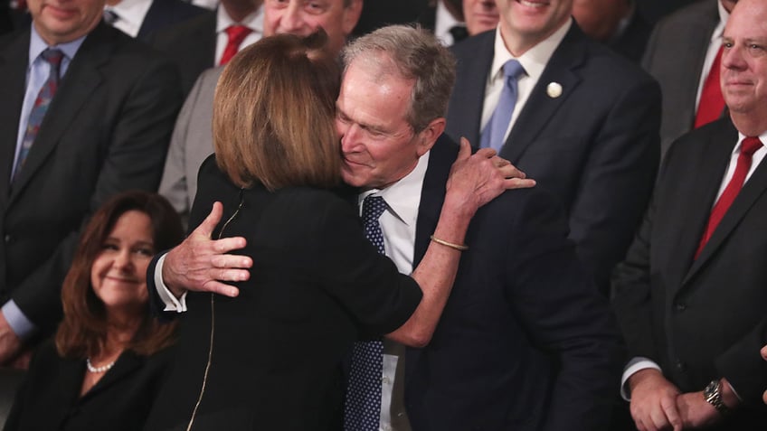 President Bush hugs Speaker Pelosi