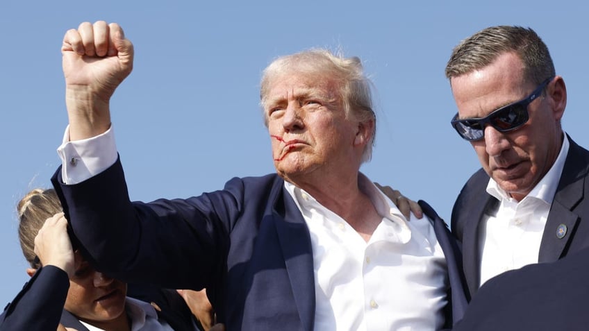 Republican presidential candidate former President Donald Trump is rushed offstage during a rally on July 13, 2024 in Butler, Pennsylvania.