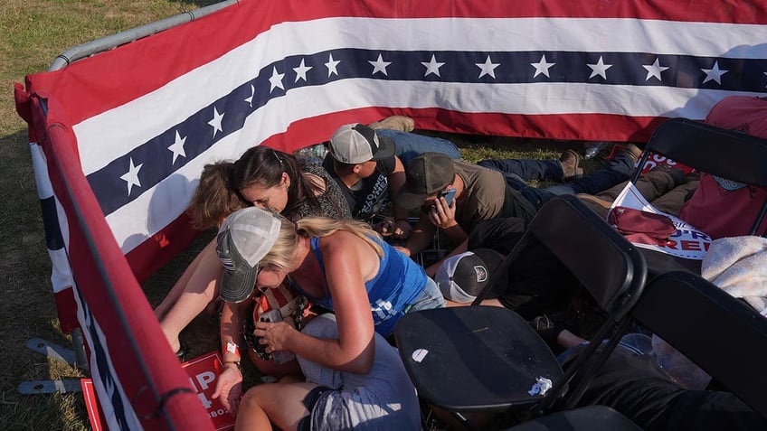 People huddle after the shooting