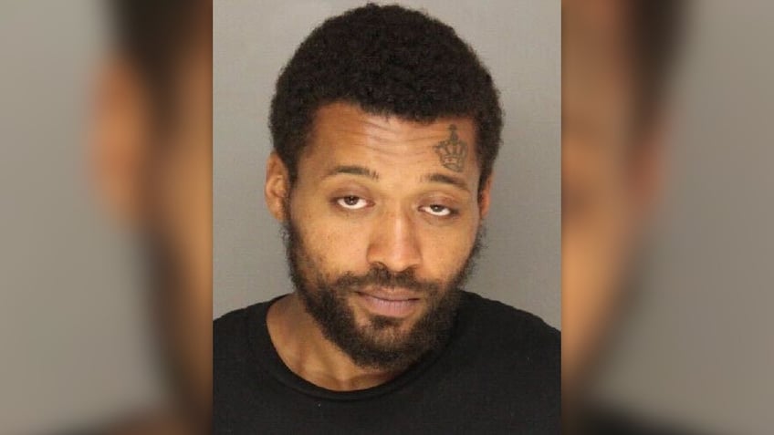 Bernard Polite has a crown tattooed over his left eyebrow in this booking photo