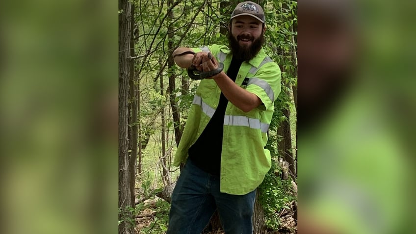 Christian Sluka holding a snake