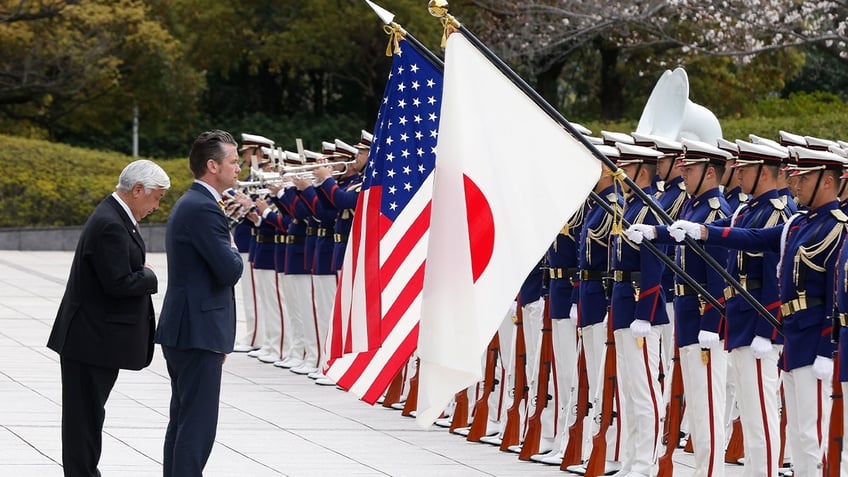 U.S. Defense Secretary Pete Hegseth and Japan’s Defense Minister Gen Nakatani inspect an honor guard during a formal welcome ceremony in Tokyo on March 30, 2025.
