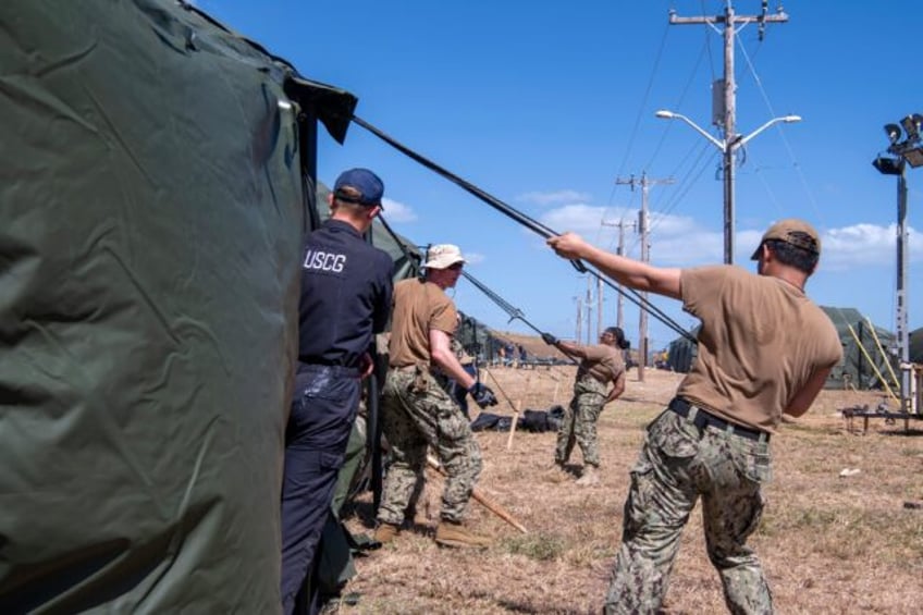 American personnel erect tents for migrant detention operations at the US military base a