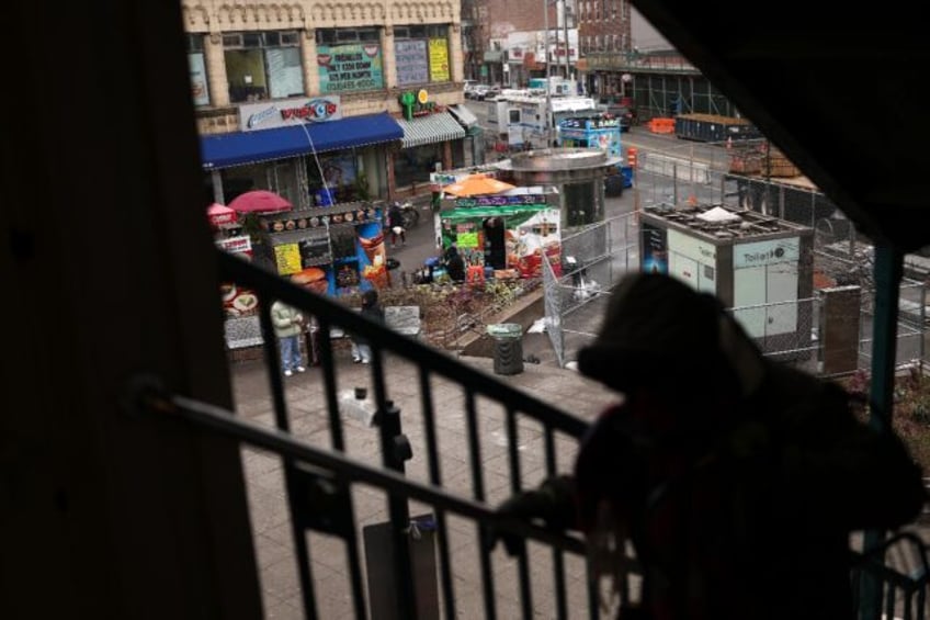 Vendors are seen below the subway station in the Corona Plaza area of the Queens borough o