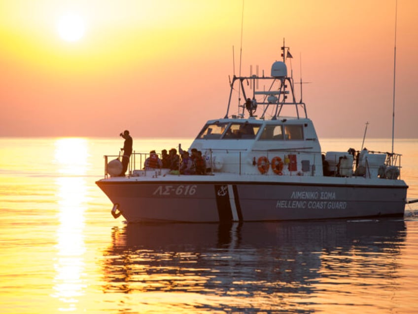 A coastguard boat with a group of migrants and refugees arrives at the port in the southea