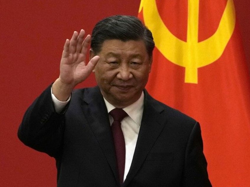 Chinese President Xi Jinping waves at an event to introduce new members of the Politburo S