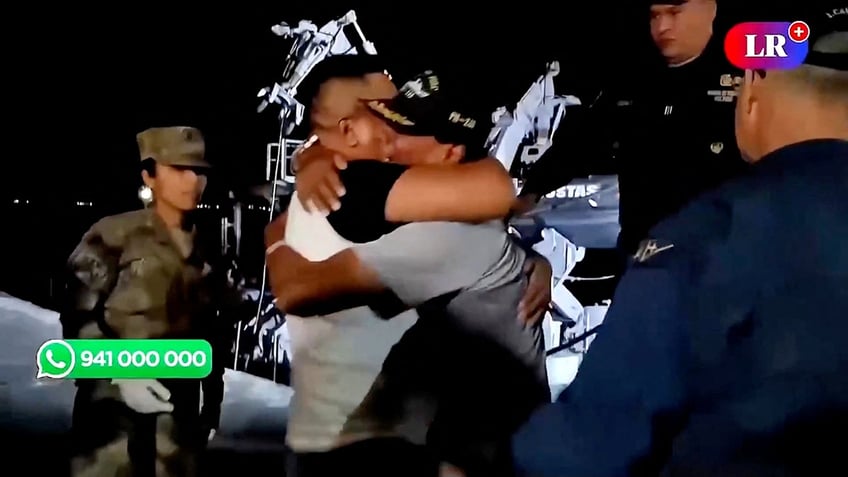 Peruvian fisherman hugs brother