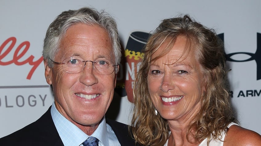 Pete Carroll smiles next to wife, Glena