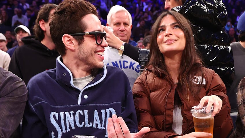 Pete Davidson smiles at Emily Ratajkowski while watching basketball game