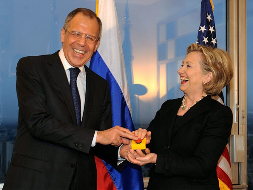 TOPSHOT - US Secretary of State Hillary Clinton (R) smiles with Russian Foreign Minister S