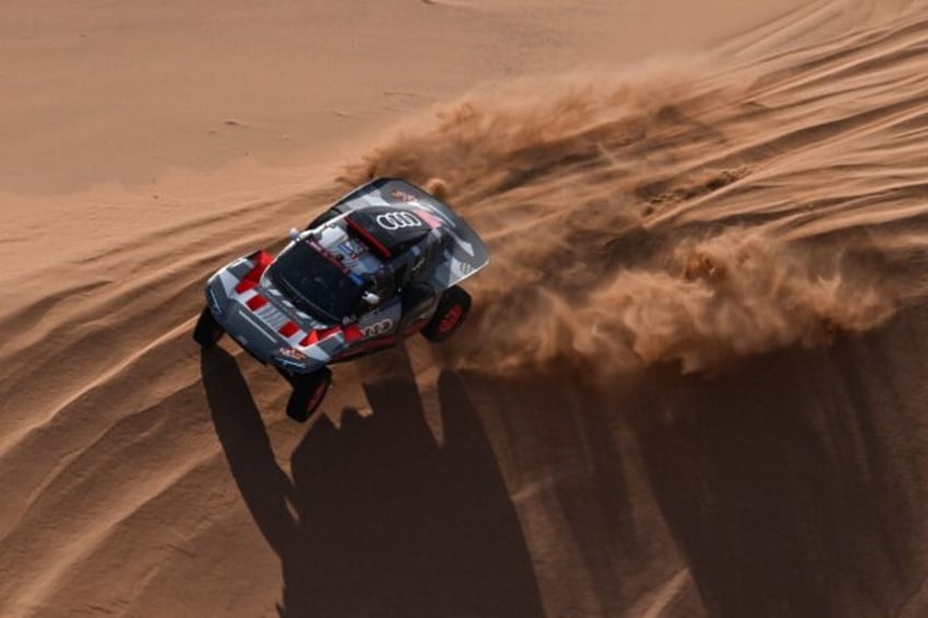 Sand man: Stephane Peterhansel en route to a record-equalling 50th Dakar stage win