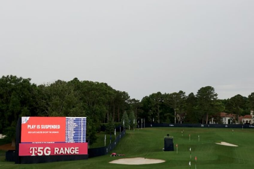 A sign at the driving range warns spectators of dangerous weather during a storm delay at