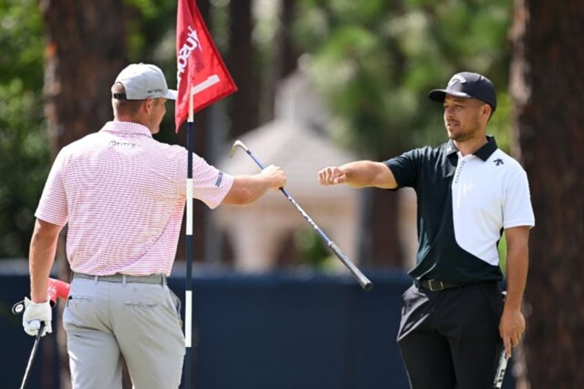 Bryson DeChambeau, left, shares a fist bump on the first tee at Pinehurst with fellow Amer
