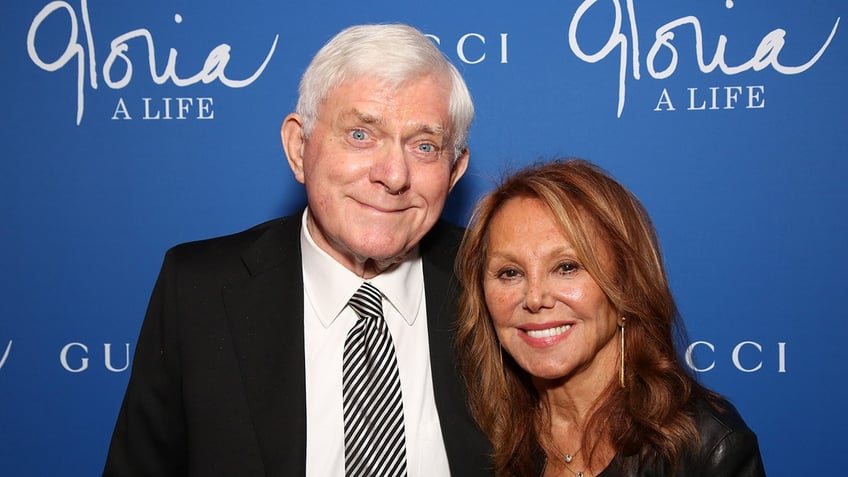 Phil Donahue and Marlo Thomas smiling together on the red carpet