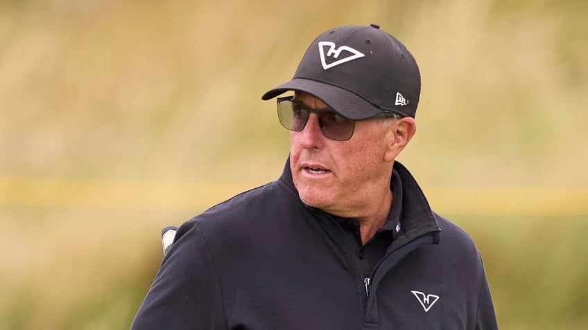 Phil Mickelson looks on during practice round