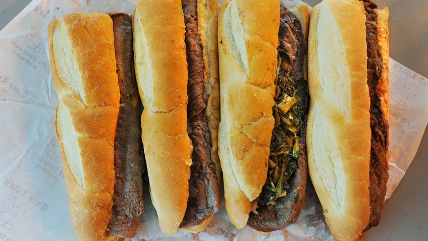 Tony Luke's cheesesteaks are shown, from left to right: steak with onions and cheez whiz, steak with onions and provolone, steak with provolone and broccoli rabe and steak with pizza sauce.