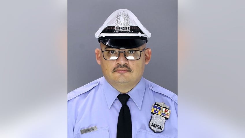 philadelphia policeman released from hospital as search continues for suspects who killed another officer