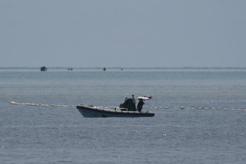 philippine coast guard says successfully removes barrier at disputed reef