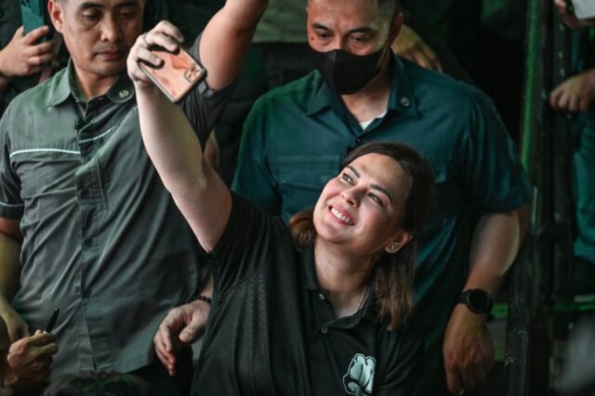 Philippines Vice President Sara Duterte snaps a selfie at a Manila campaign rally