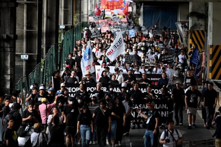 Hundreds of Filipino protesters marched through Manila to mark the 38th anniversary of the