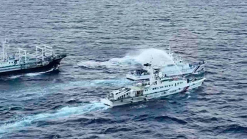 Chinese boat using water cannon of Philippine boat