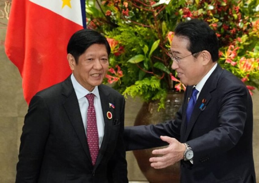 Japan's Prime Minister Fumio Kishida greets Philippines' President Ferdinand Marcos Jr. on