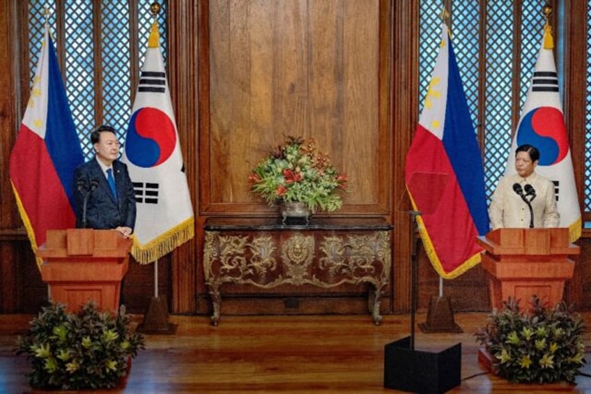 Philippine President Ferdinand Marcos (R) alongside his South Korean counterpart Yoon Suk