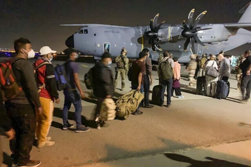 Tens of thousands of Afghans scrambled to leave the country in the chaotic evacuation of A