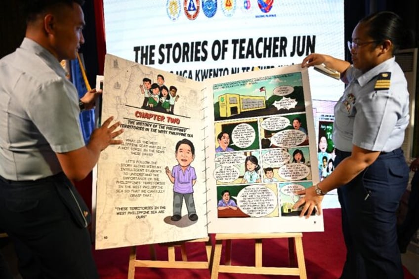 Philippine Coast Guard personnel arrange a version of a mockup comic book on the South Chi