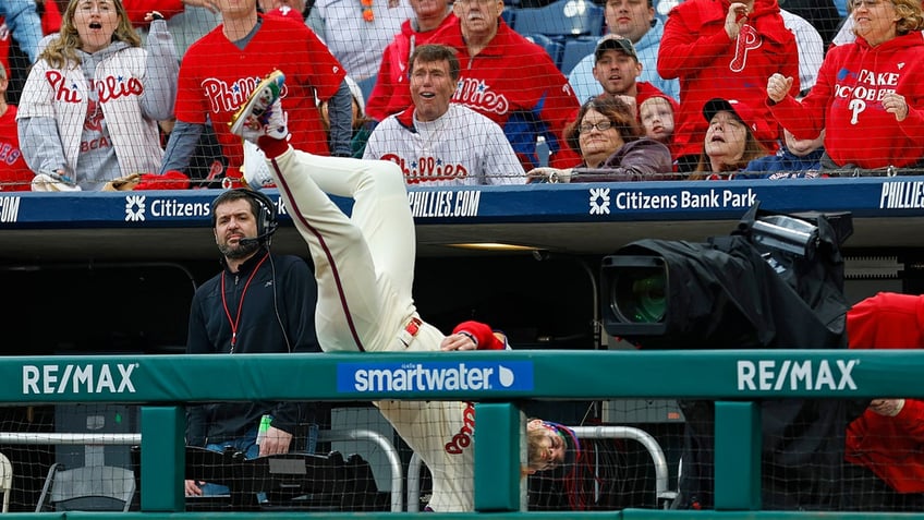 Bryce Harper flips over fence