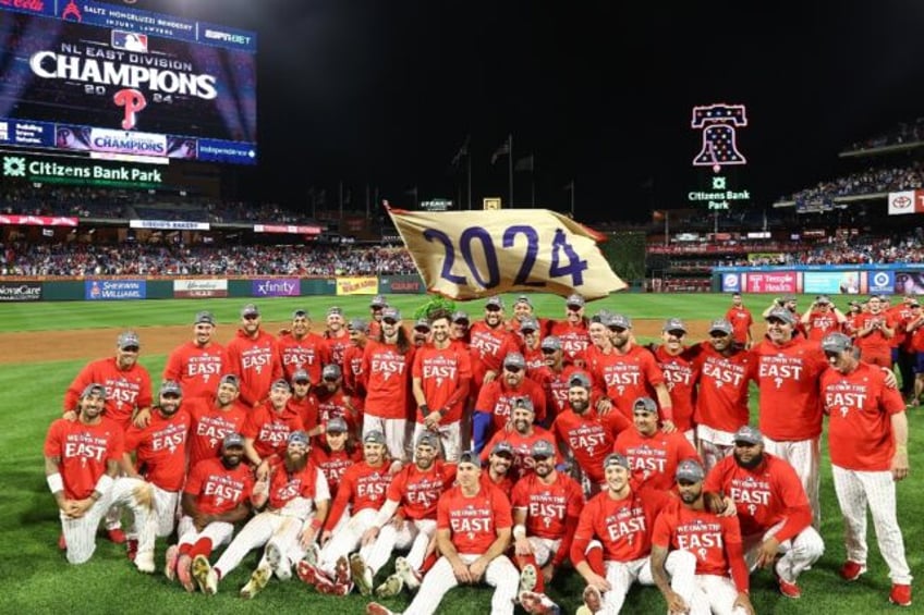 The Philadelphia Phillies celebrate after clinching the NL East title for the first time i