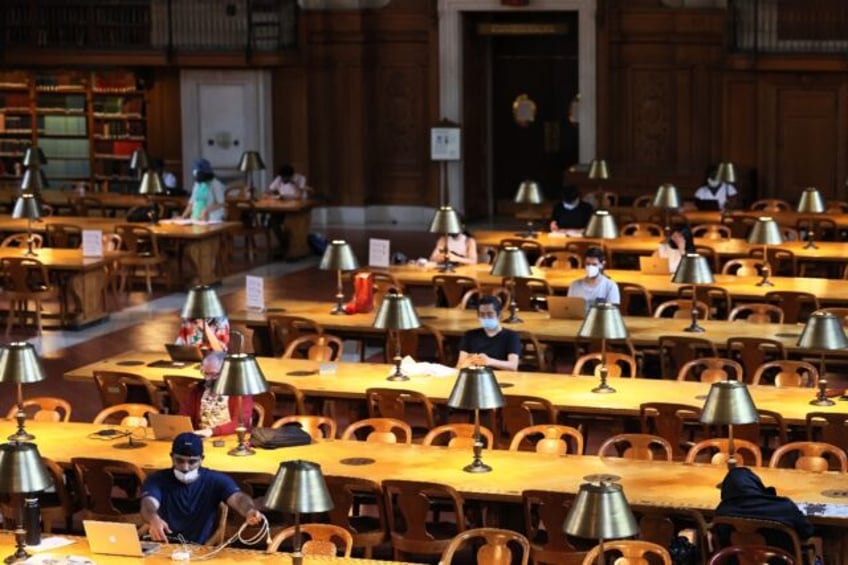 People read their computers in the New York Public Library in July 2021 in Manhattan