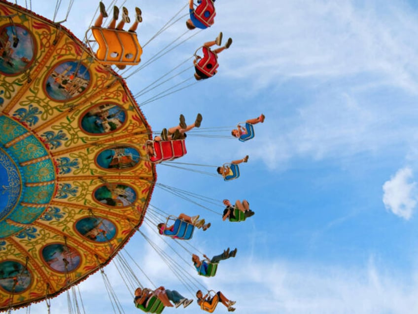 People Riding Carousel in Park