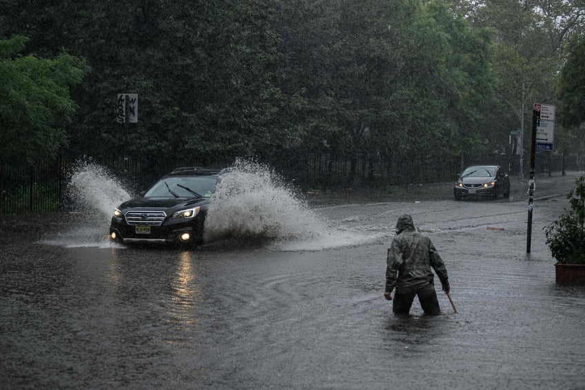 photos heavy rains bring flash floods to new york city roads and subways paralyzed as state of emergency declared