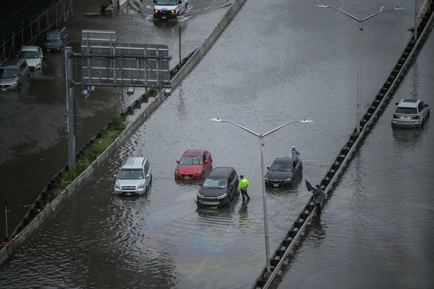 photos heavy rains bring flash floods to new york city roads and subways paralyzed as state of emergency declared