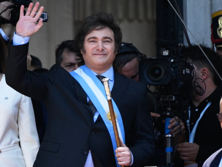 Argentina's new president Javier Milei waves next to his vice president Victoria Villarruel after being sworn in during his inauguration ceremony at the Congress in Buenos Aires on December 10, 2023. Libertarian economist Javier Milei was sworn in Sunday as Argentina's president, after a resounding election victory fueled by fury over the country's economic crisis. "I swear to God and country... to carry out with loyalty and patriotism the position of President of the Argentine Nation," he said as he took the oath of office, before outgoing President Alberto Fernandez placed the presidental sash over his shoulders. (Photo by Luis ROBAYO / AFP)