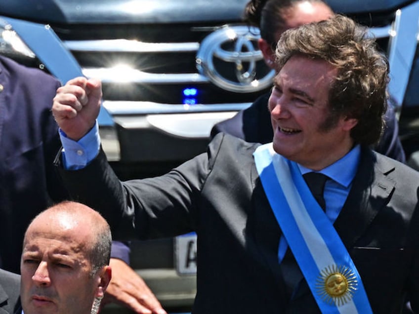 Argentina's new president Javier Milei gestures as he heads in an open car to Casa Rosada Presidential Palace after he was sworn in during an inauguration ceremony at the Congress in Buenos Aires on December 10, 2023. Libertarian economist Javier Milei was sworn in Sunday as Argentina's president, after a …